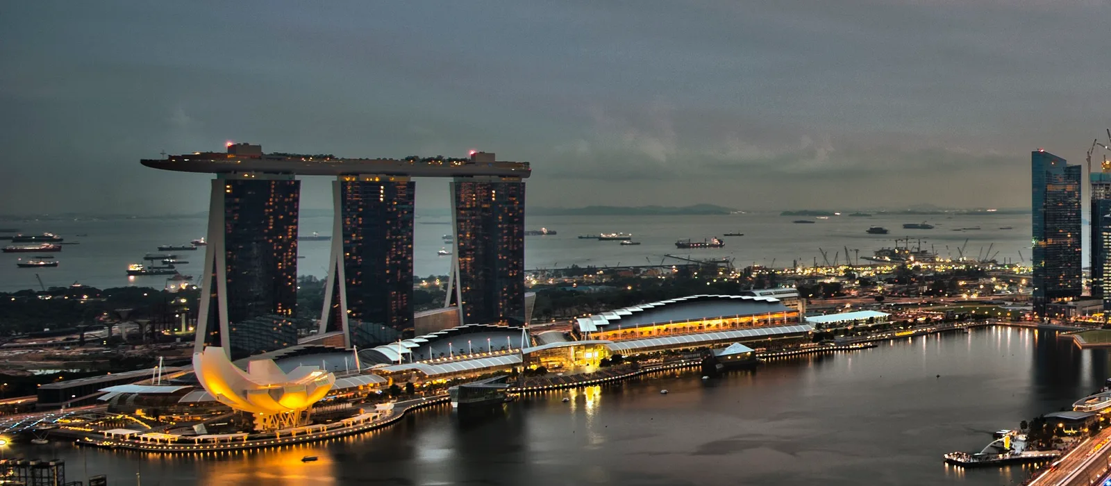 The Singapore skyline at dusk across Marina Bay
